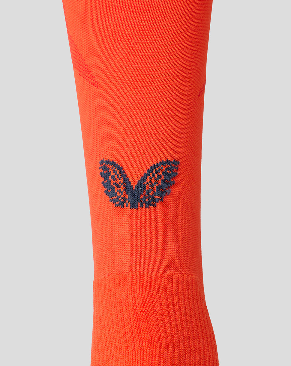 Bright orange Feyenoord third sock close up with navy F crest on the shin and Castore logo on the calf