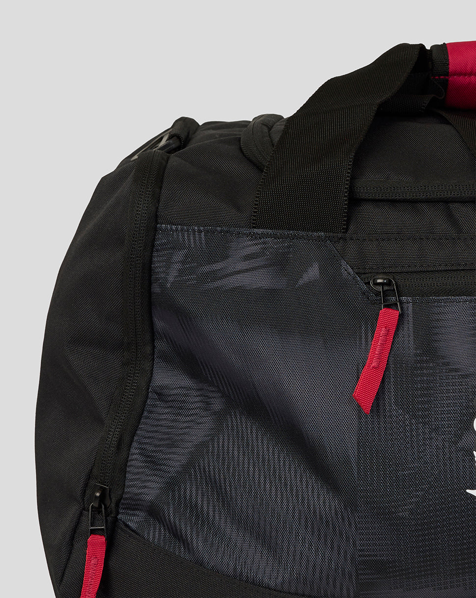 Black backpack with red accents on a light gray background