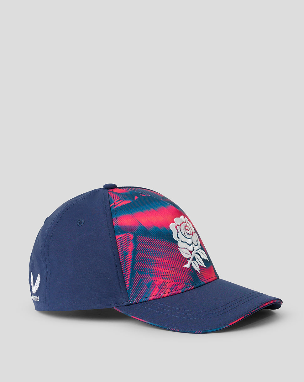 Blue cap with pink and white design on a gray background