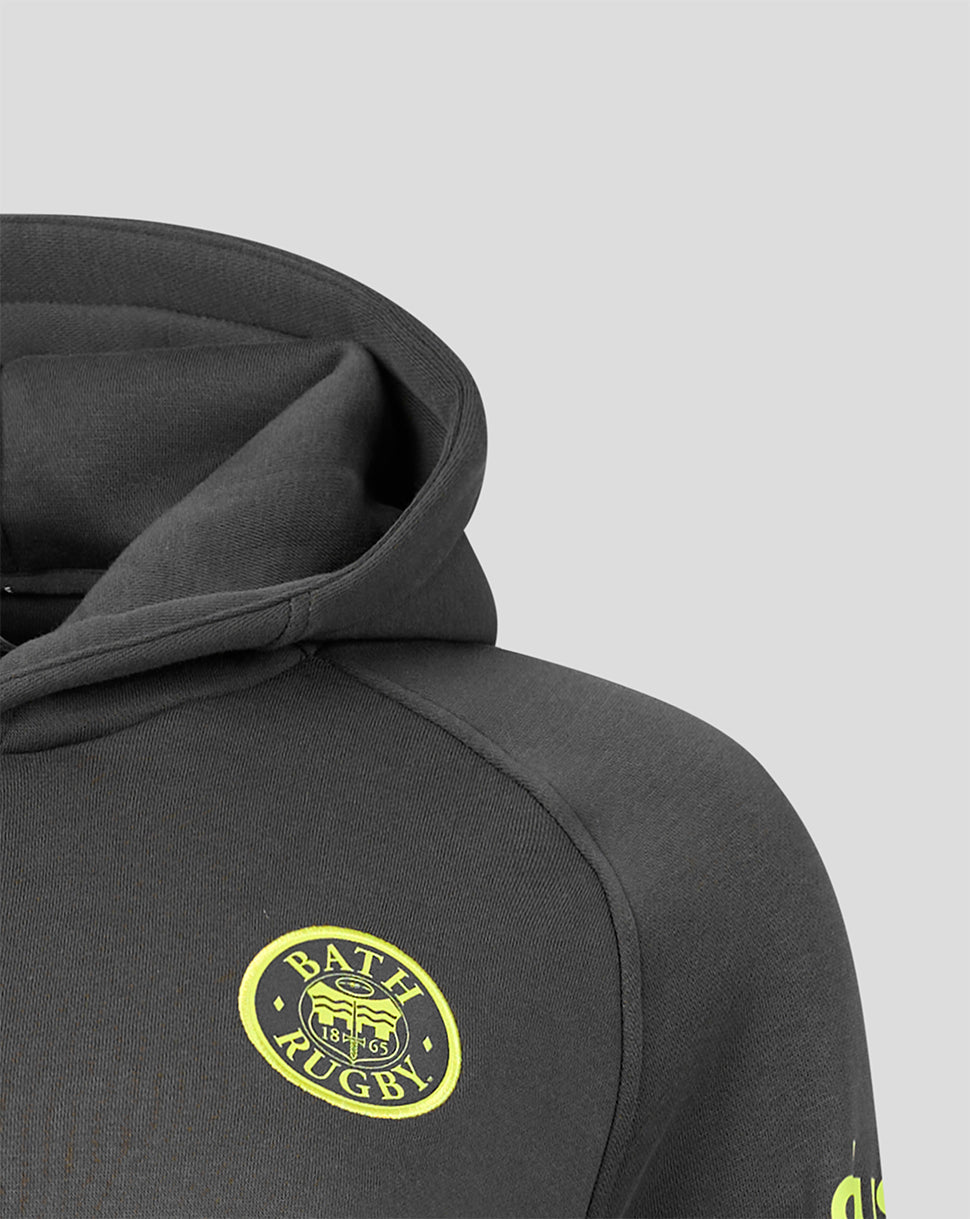 Close-up of a dark gray hoodie featuring a circular yellow and black Bath Rugby logo on the chest, set against a light gray background.