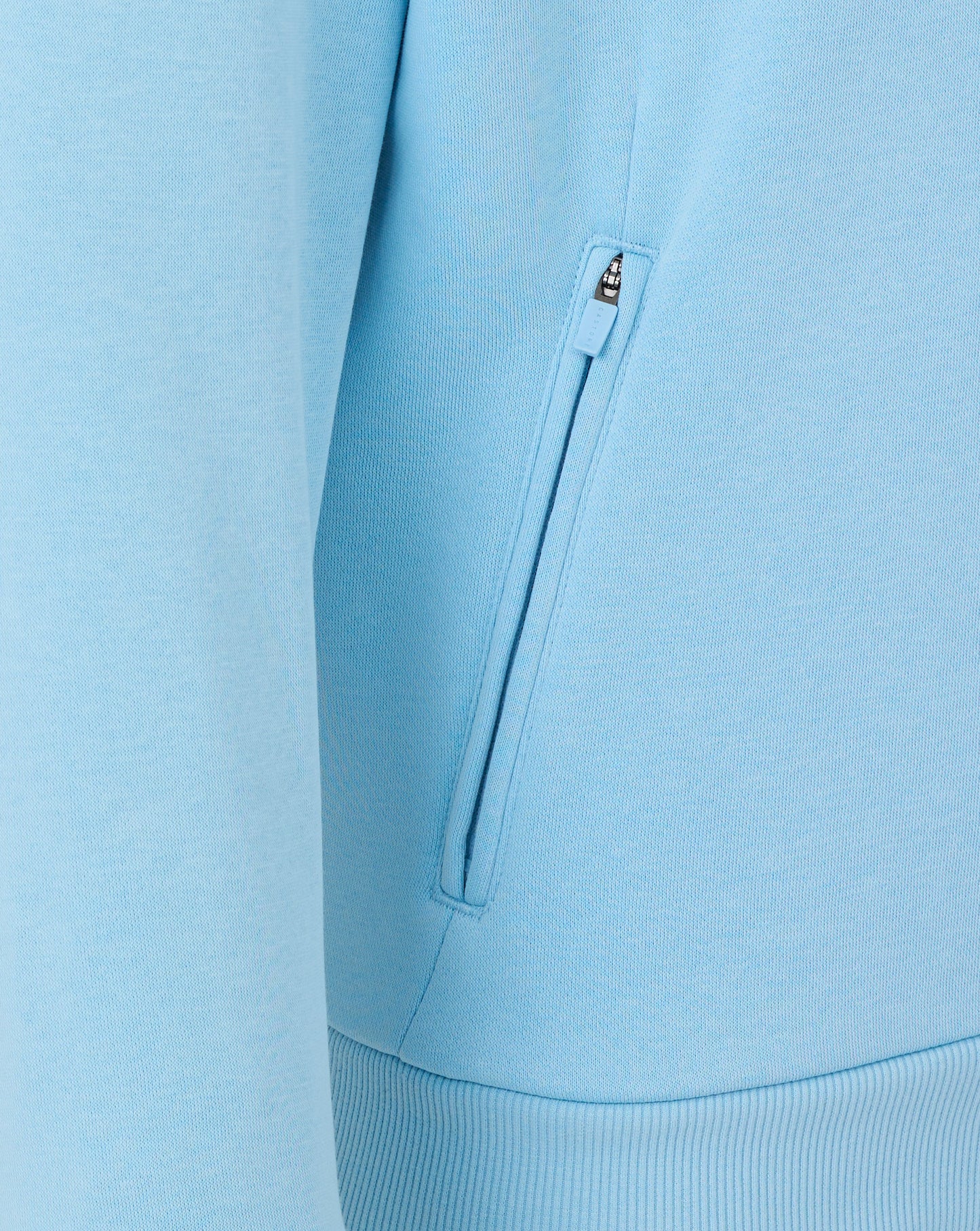 Light blue jacket with a zipper detail on a matching background
