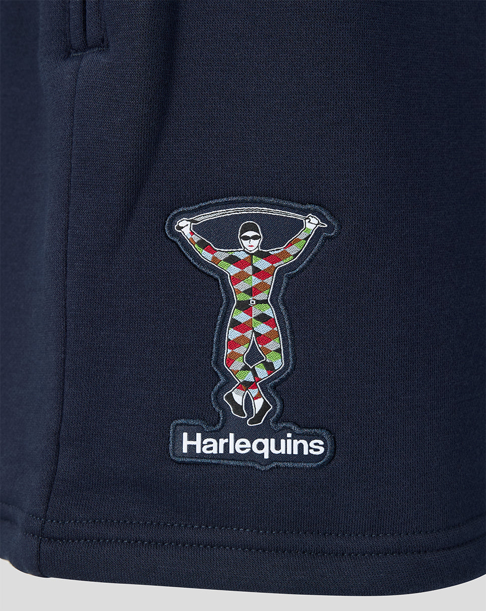 Navy blue fabric with a colorful embroidered design and 'Harlequins' branding.