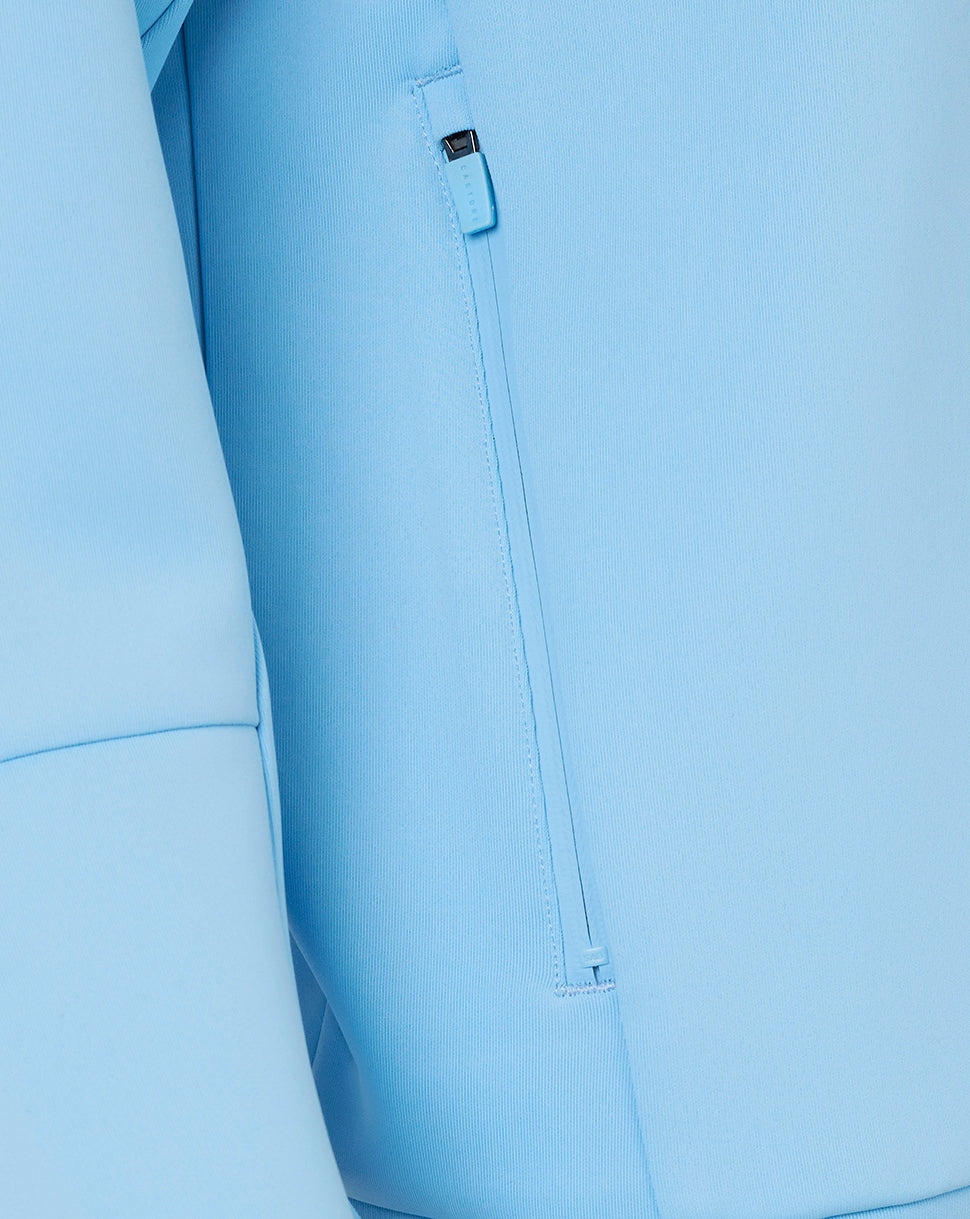 Close-up of light blue pants with a zipper pocket.