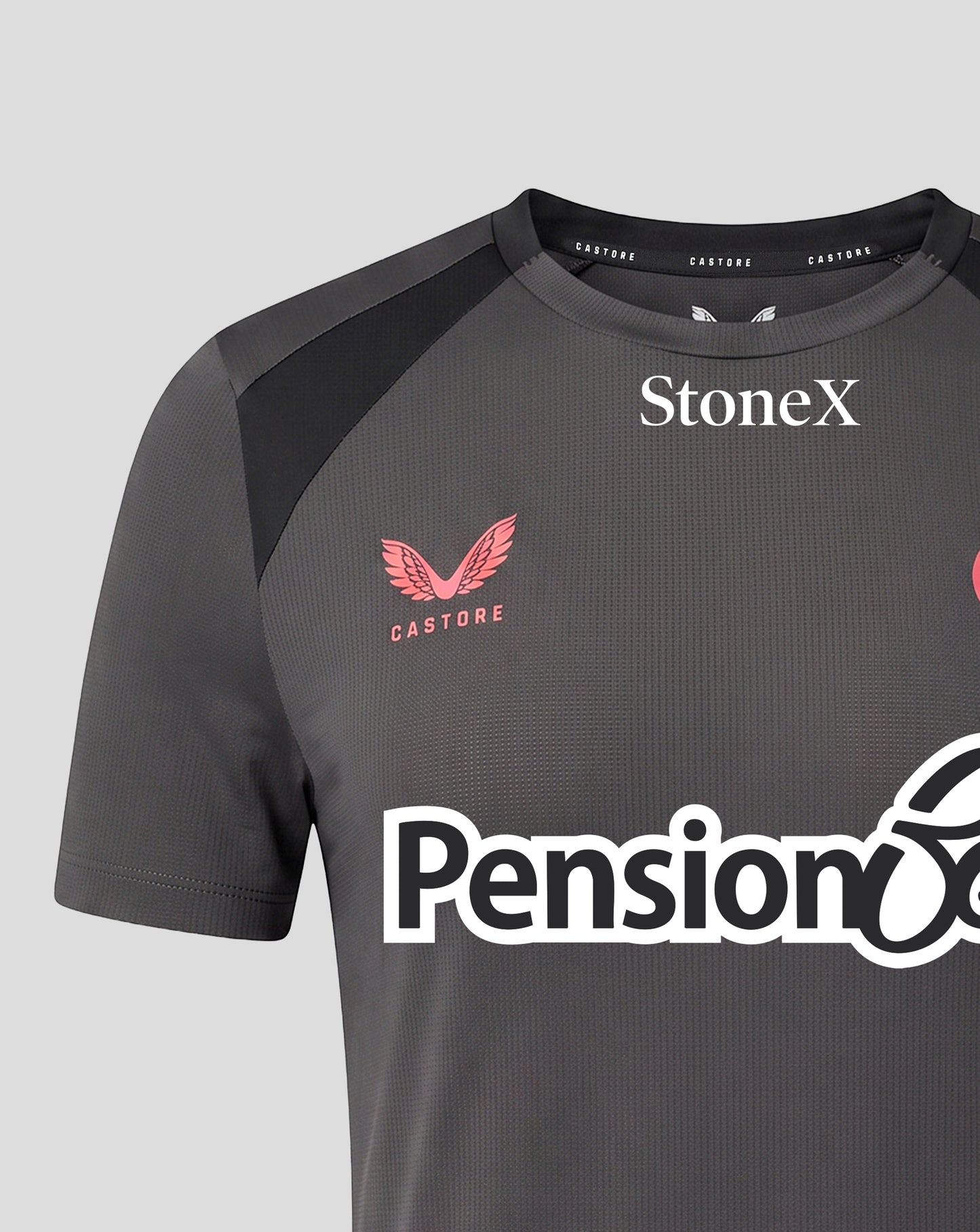A dark gray athletic t-shirt with black shoulder panels, featuring the StoneX logo in white on the chest, a red Castore wing logo, and a large white PensionX logo across the front.