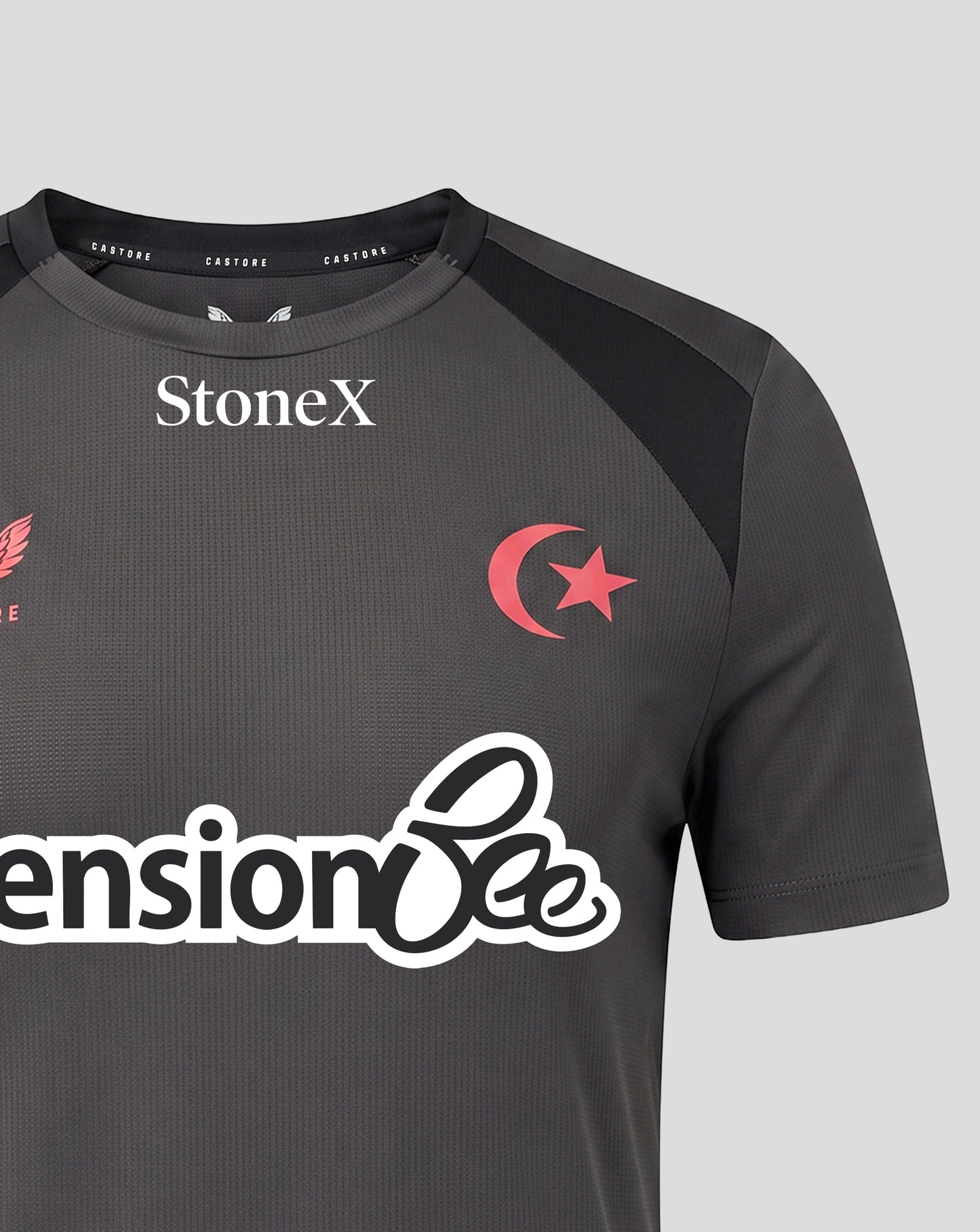 A close-up of a dark gray athletic jersey with black shoulder panels, featuring the white StoneX logo on the chest, a red crescent and star emblem, and a large white 'Pension Bee' sponsor logo across the front.
