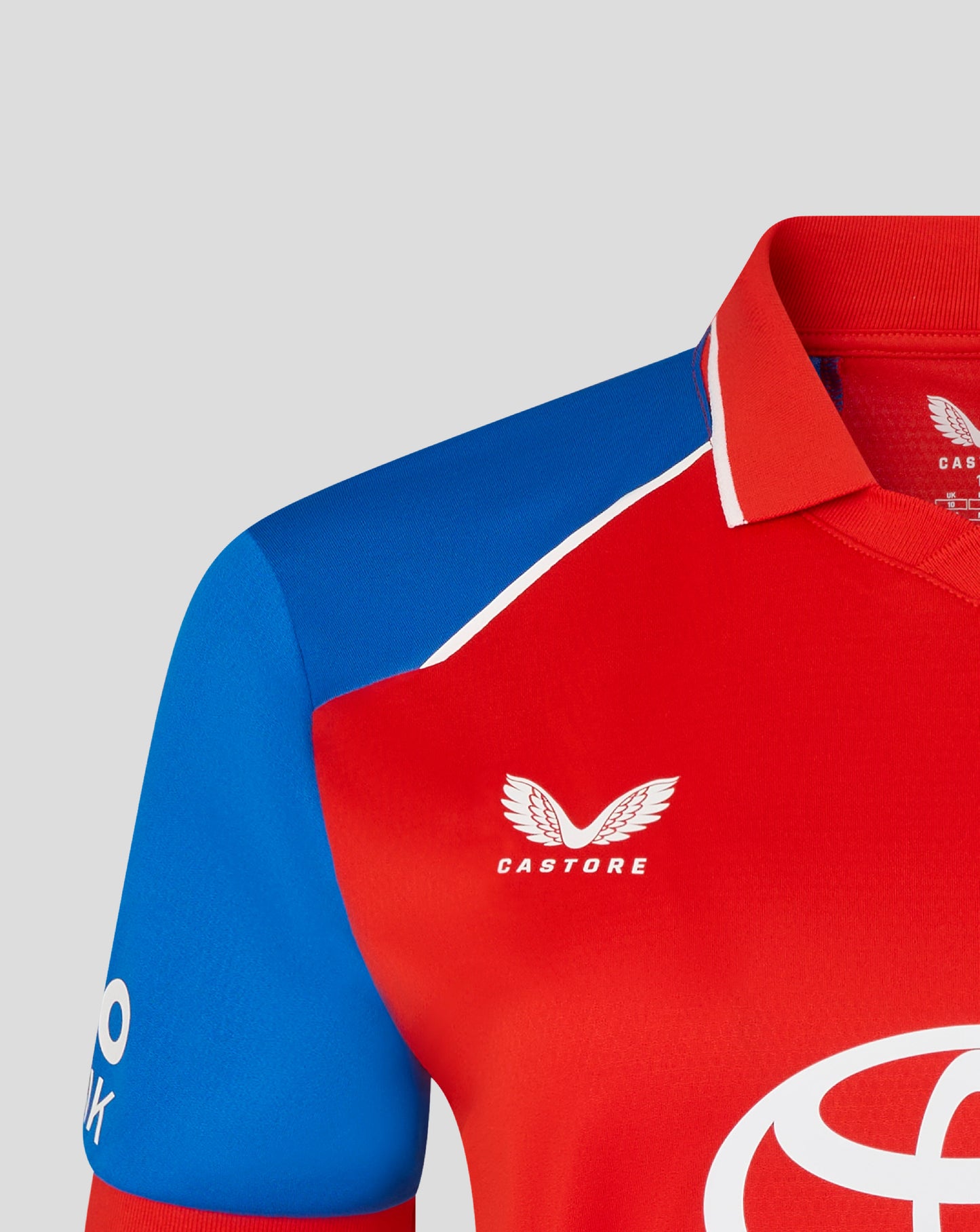 Red and blue sports jersey with Castore and Toyota logos on a gray background