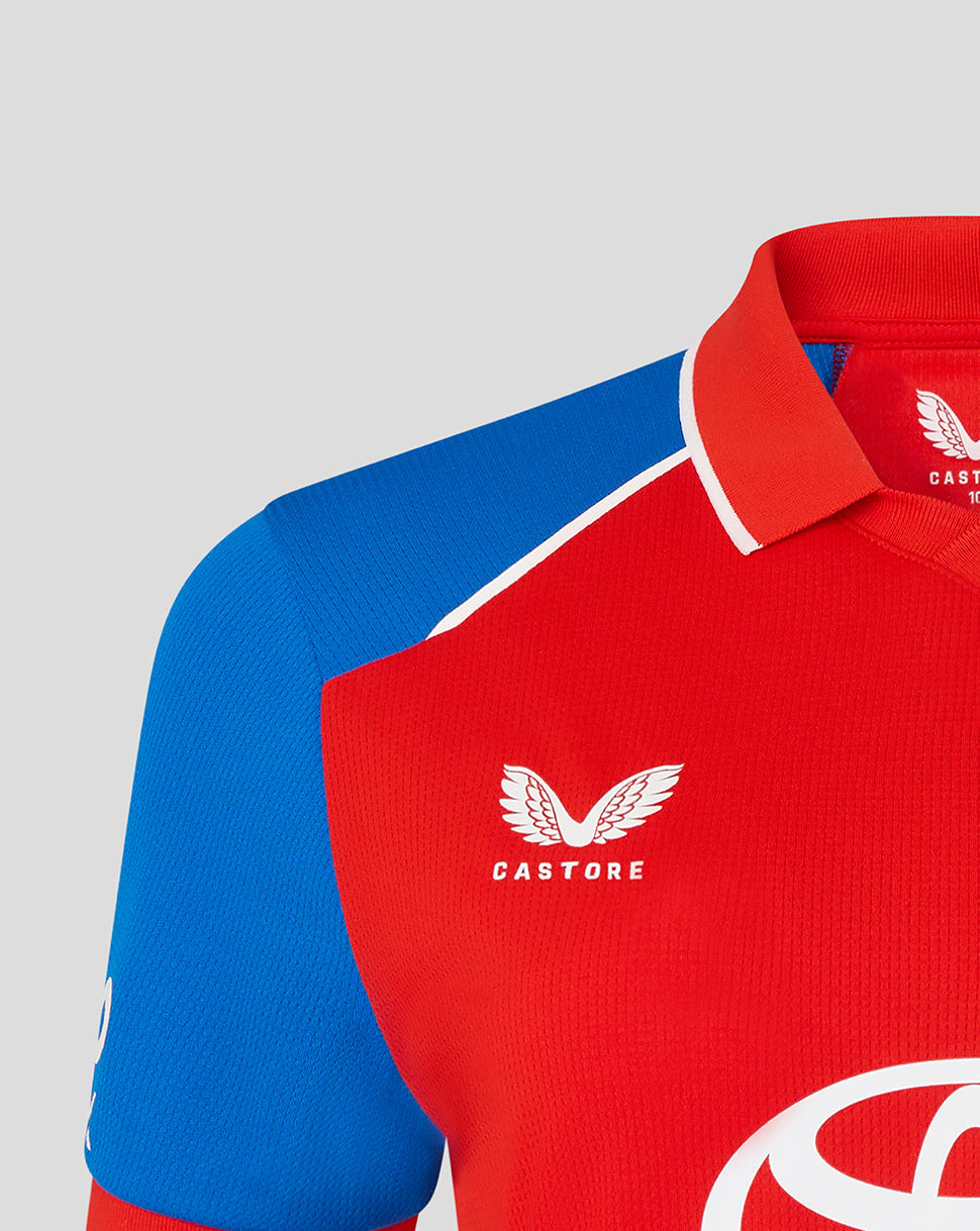 Red and blue sports jersey with Castore logo on a gray background