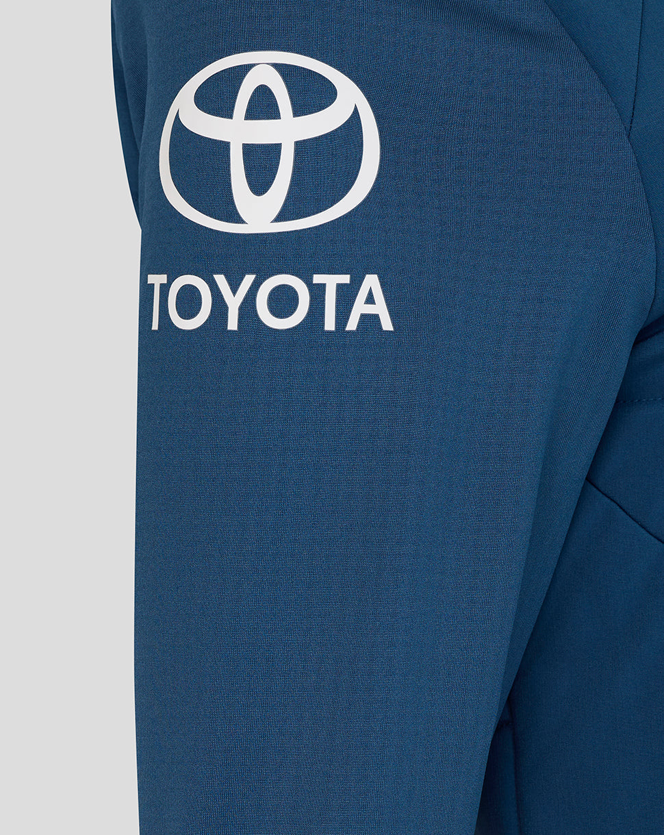Close-up of a blue jacket with Toyota logo on a light gray background