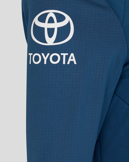 Close-up of a blue jacket with Toyota logo on a light gray background