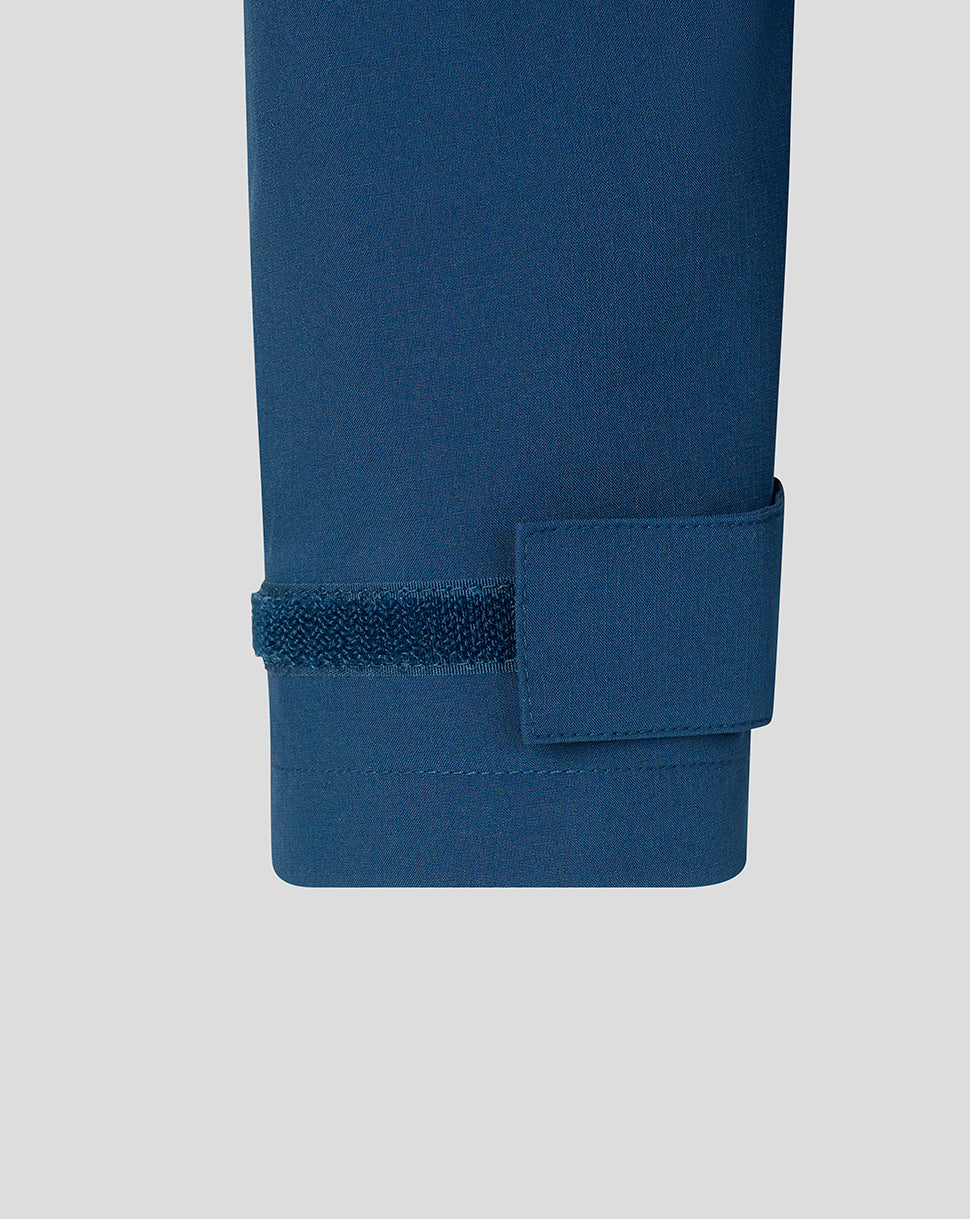 Close-up of a blue fabric with a textured pattern on a light gray background