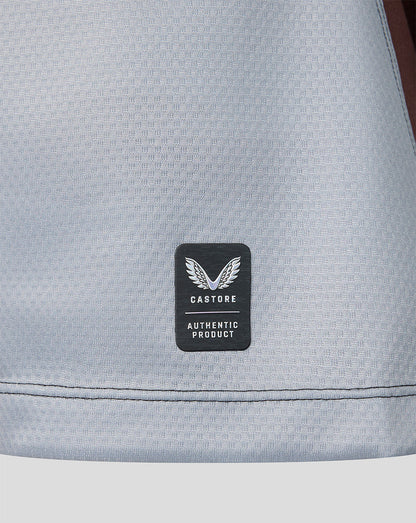 Gray textured fabric with a black label featuring 'Castore' branding.