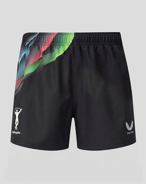 Black athletic shorts featuring a vibrant, abstract multicolor graphic print on the left side, with white logos for 'Harlequins' on the left leg and 'Castore' on the right leg, displayed against a neutral gray background.