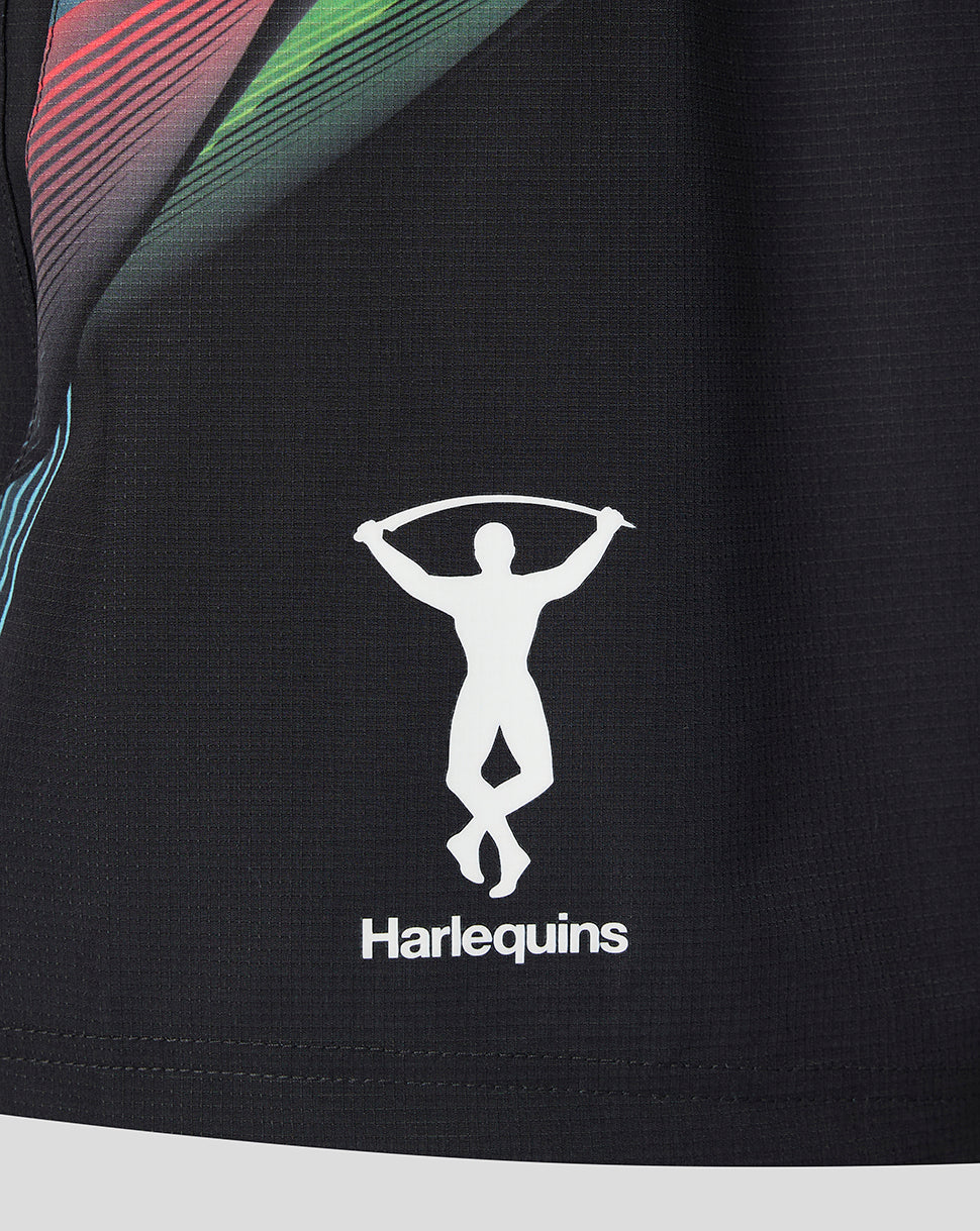 Close-up of a black athletic jersey with a white Harlequins logo featuring a leaping figure and the brand name 'Harlequins' printed below it.