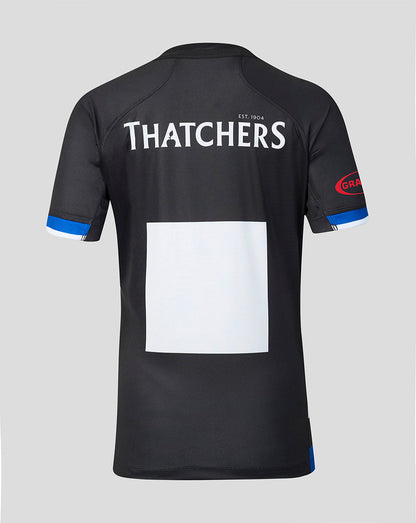 Black short-sleeve athletic jersey shown from the back on a light gray background, with large white 'THATCHERS' text across the upper back, a blank white rectangular patch in the center, blue trim at the sleeve cuffs, and a red circular logo on the right sleeve.