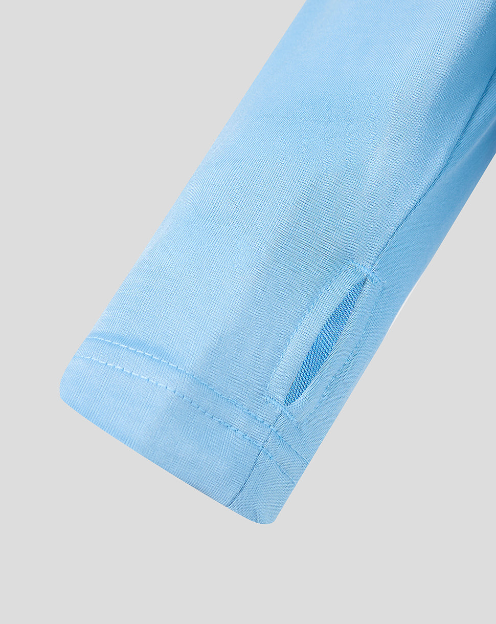 Close-up of a light blue fabric edge on a gray background
