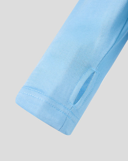 Close-up of a light blue fabric edge on a gray background