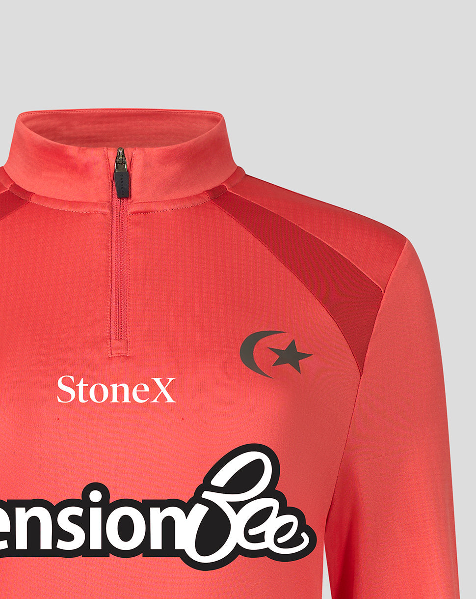 A close-up of a coral red athletic quarter-zip jacket featuring a black crescent and star logo on the chest, the white 'StoneX' brand name, and a large black-and-white sponsor logo at the bottom.