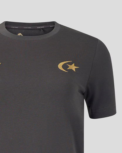 A close-up of a dark gray crewneck t-shirt featuring a gold embroidered crescent and star logo on the left chest, set against a solid light gray background.