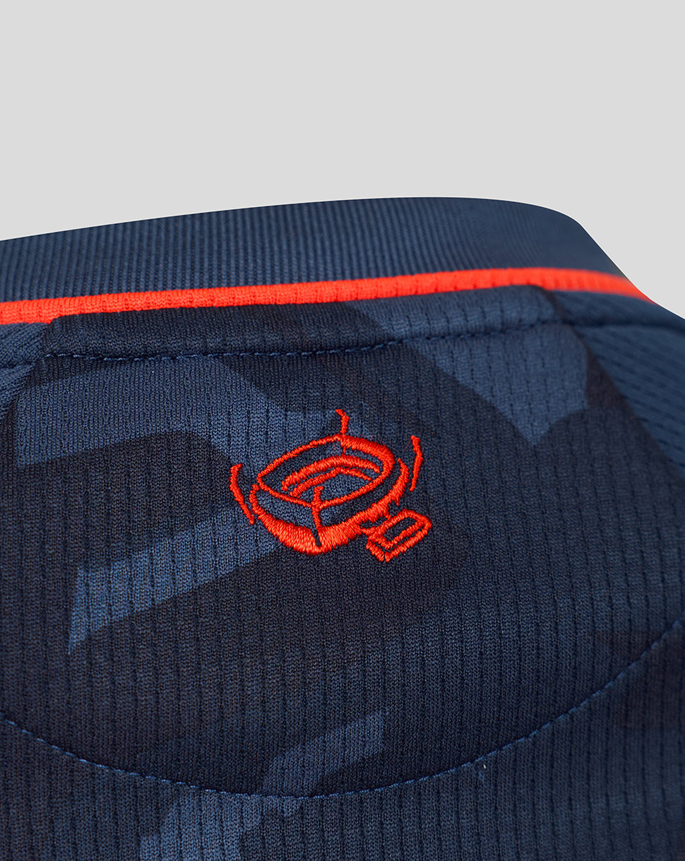 Close-up of the navy Feyenoord third shirt with red collar trim and a red embroidered crest on the left chest.