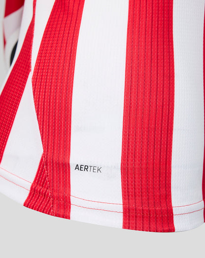 Close up of red and white stripes on the Athletic Club shirt with AERTEK label at the hem.