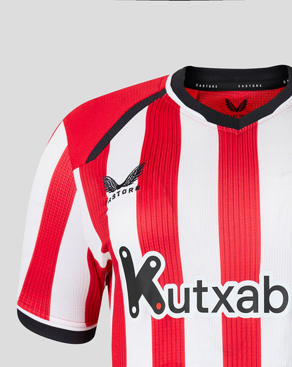 Close-up of the front shoulder area showing Castore branding and red white stripes on the Athletic Club jersey.