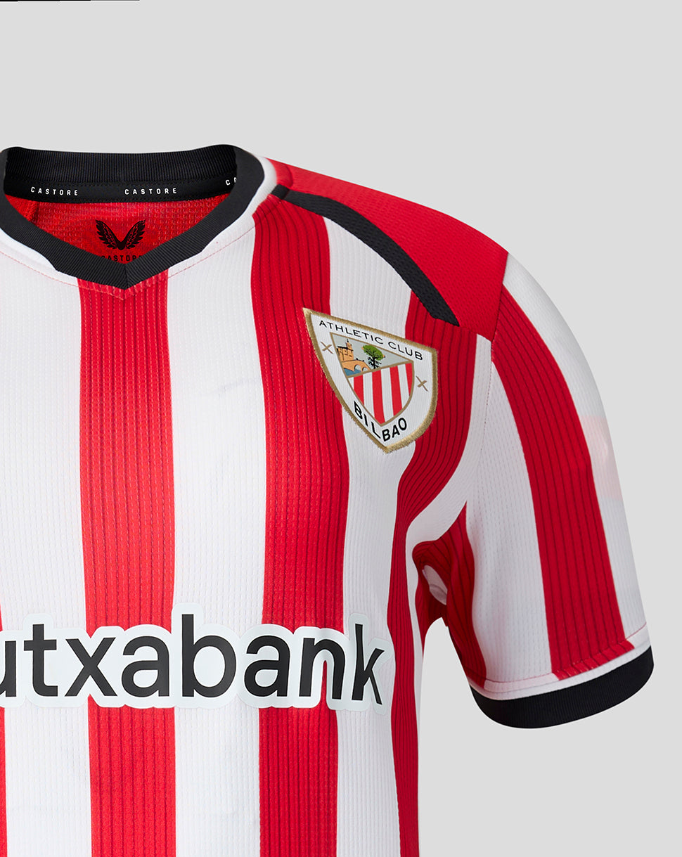 Athletic Club Bilbao home shirt close up showing red and white vertical stripes and the club crest on the chest.