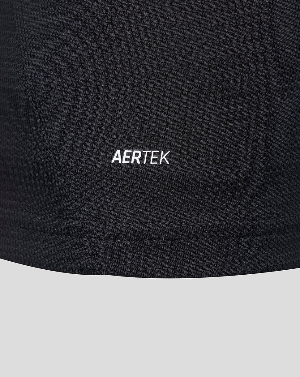 Detail shot of black jersey fabric showing AERTEK branding near the hem