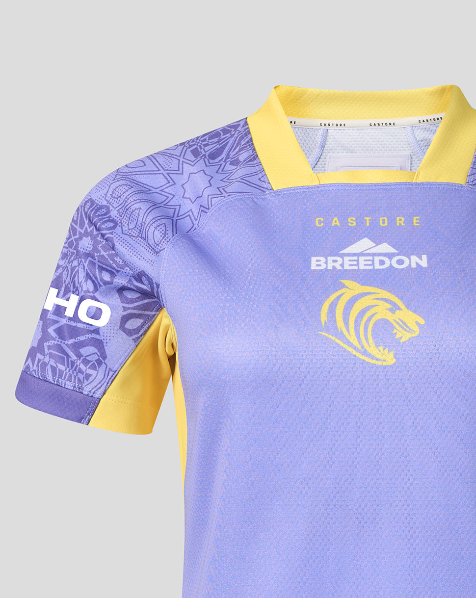 A close-up of a light purple and yellow sports jersey with 'BREEDON' and a lion logo on the chest, and 'CASTURE' on the collar label.