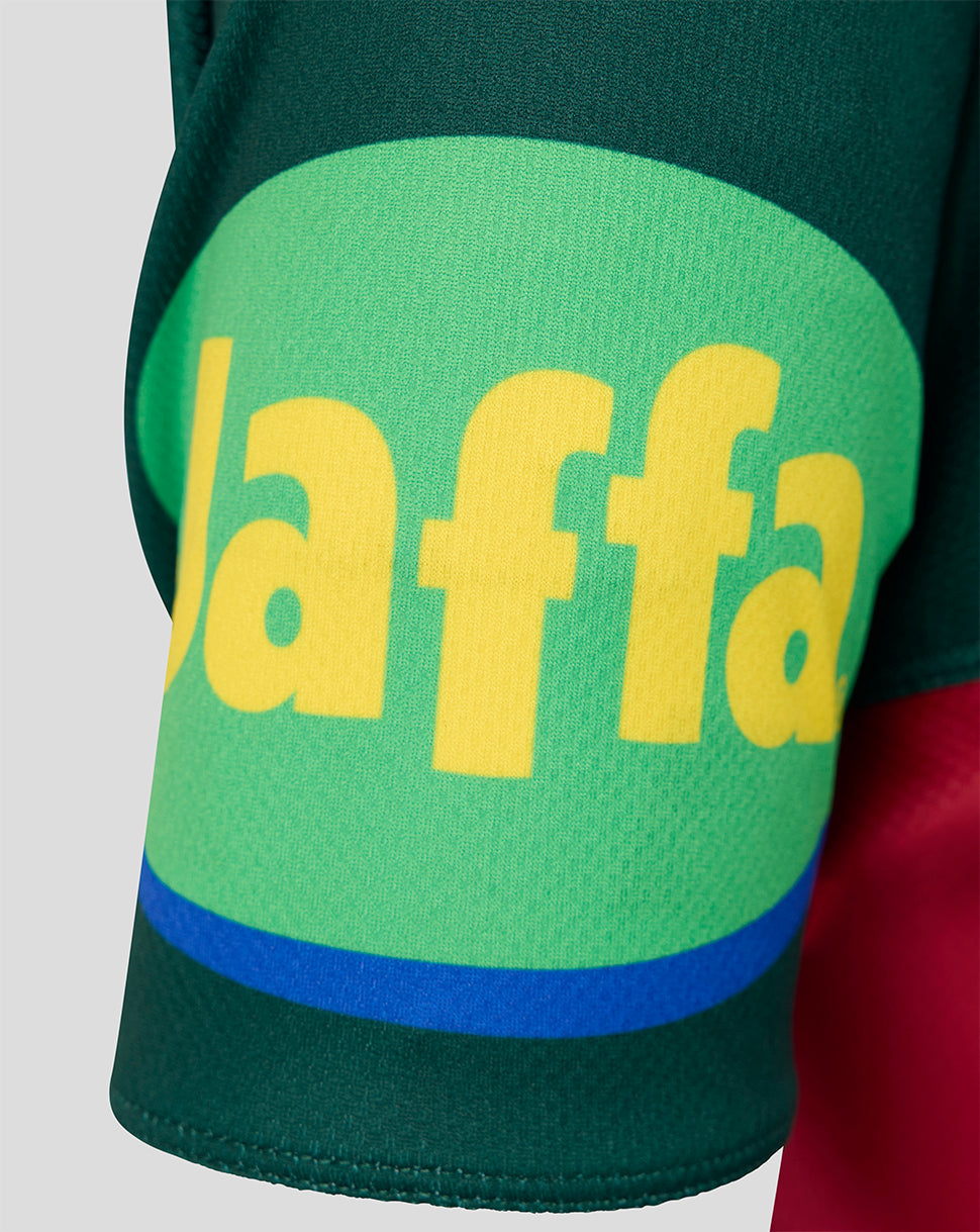 Close-up of a dark green athletic jersey sleeve featuring a large green oval patch with yellow 'laafa' lettering and a blue curved stripe near the cuff.