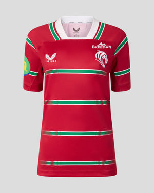 A red short-sleeve rugby jersey with green and white horizontal stripes, featuring the Bredon logo on the left chest, a white Castore logo on the right chest, and a green and yellow sleeve patch, shown against a solid gray background.