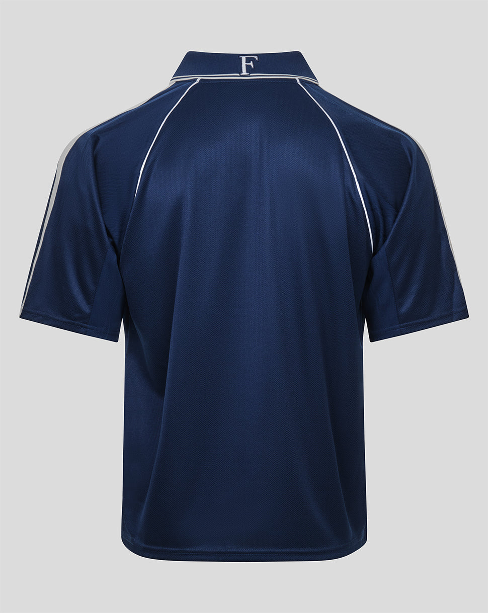 A navy blue short-sleeve polo shirt shown from the back, featuring white contrast stitching along the shoulders and collar, with a white monogram letter 'F' on the collar.