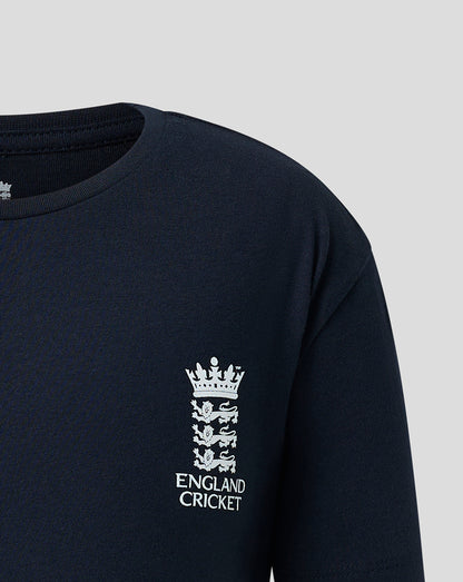 Close-up of a dark navy long-sleeve shirt with a white England Cricket crest and text printed on the left chest, shown against a light gray background.