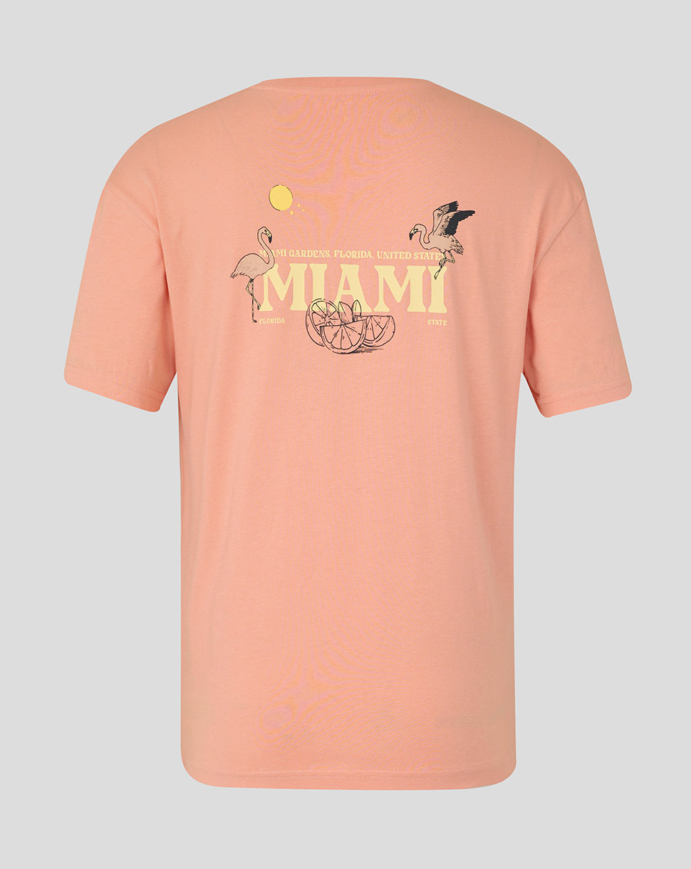 Back view of coral pink unisex Miami graphic T-shirt with large MIAMI print and tropical motif on the lower back