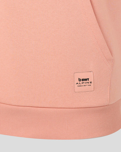 Close up of the peach pink hoodie hem showing a BWT Alpine patch near the lower side