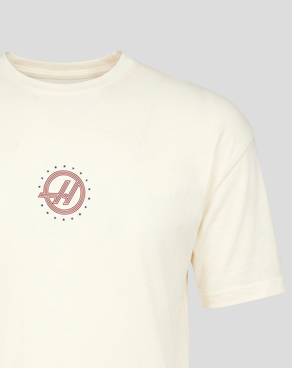 Close up of circular red and blue Haas F1 Team roundel on left chest of white T shirt.