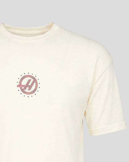 Close up of circular red and blue Haas F1 Team roundel on left chest of white T shirt.