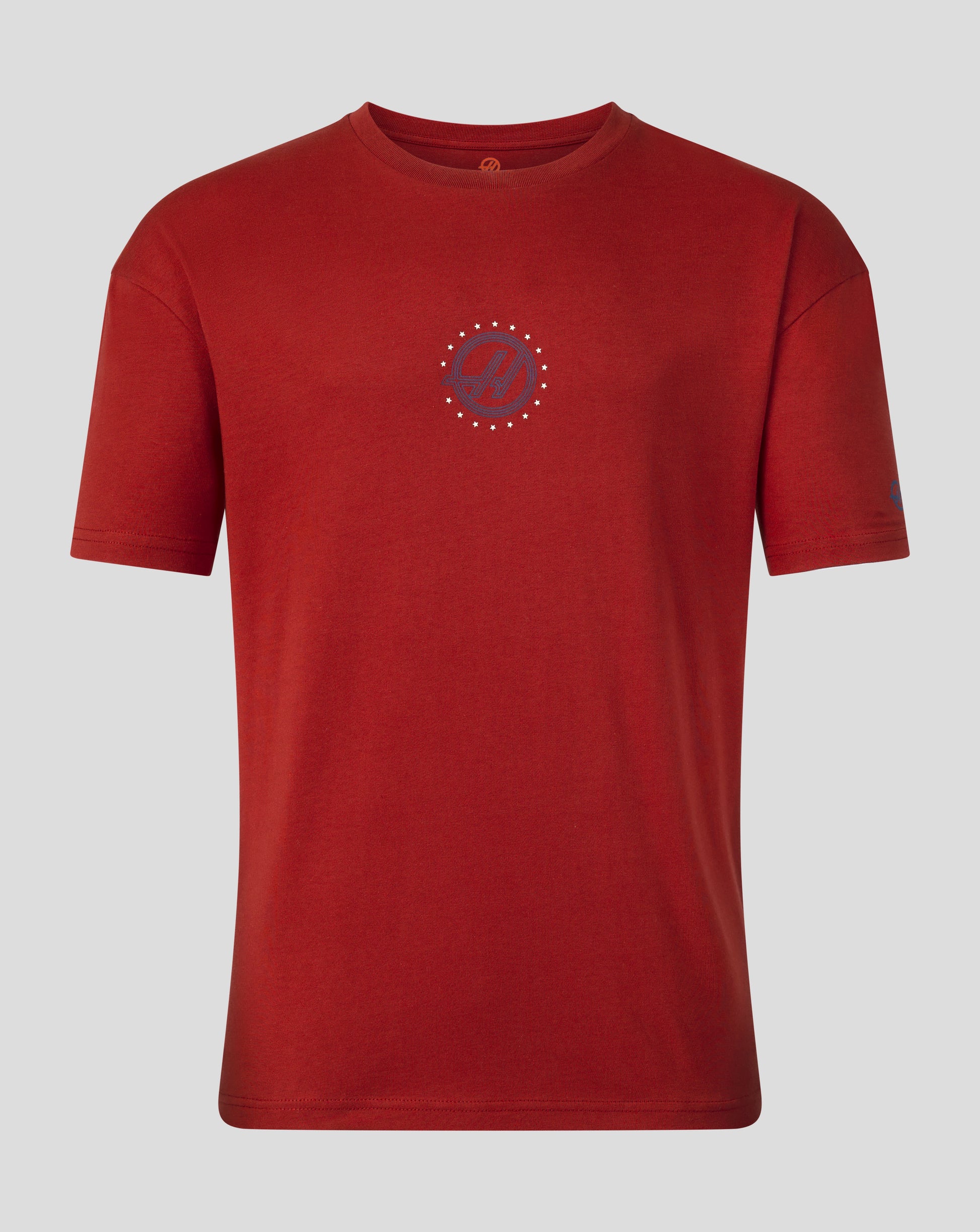 A red short-sleeve crewneck t-shirt with a circular chest graphic featuring a dark red 'H' inside a circle surrounded by small gold dots, displayed on a neutral gray background.