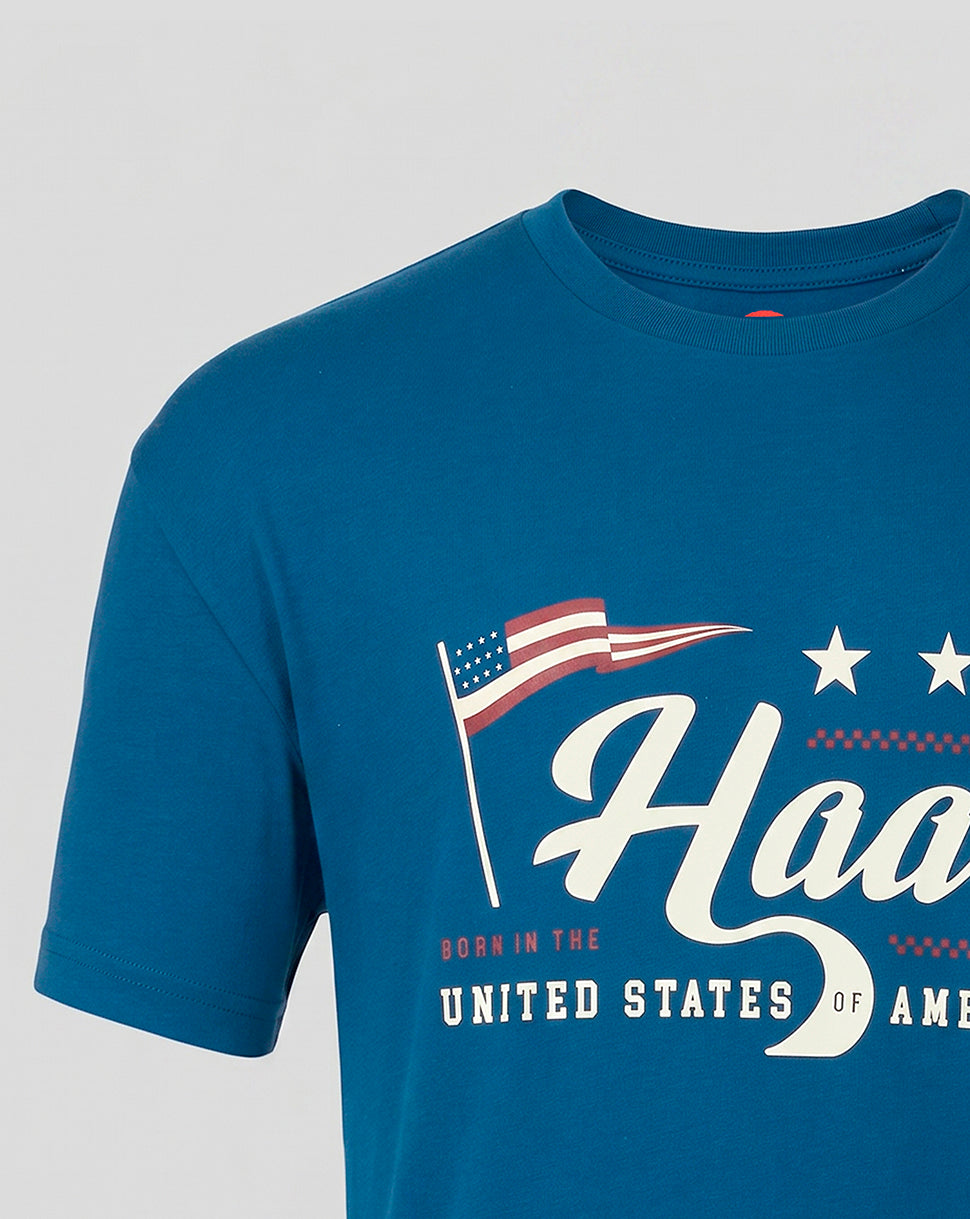 Close up of blue Haas T shirt front graphic with waving American flag and bold Haas script