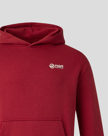 A close-up of a heathered red pullover hoodie with a small white TGR Technology logo on the left chest, set against a solid light gray background.