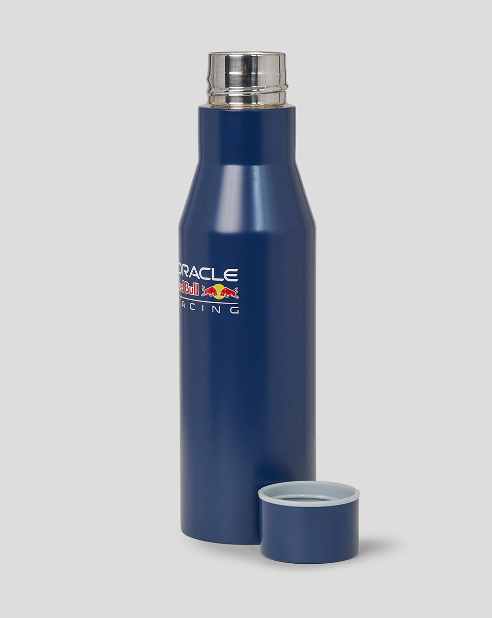 Blue water bottle with a silver cap on a gray background