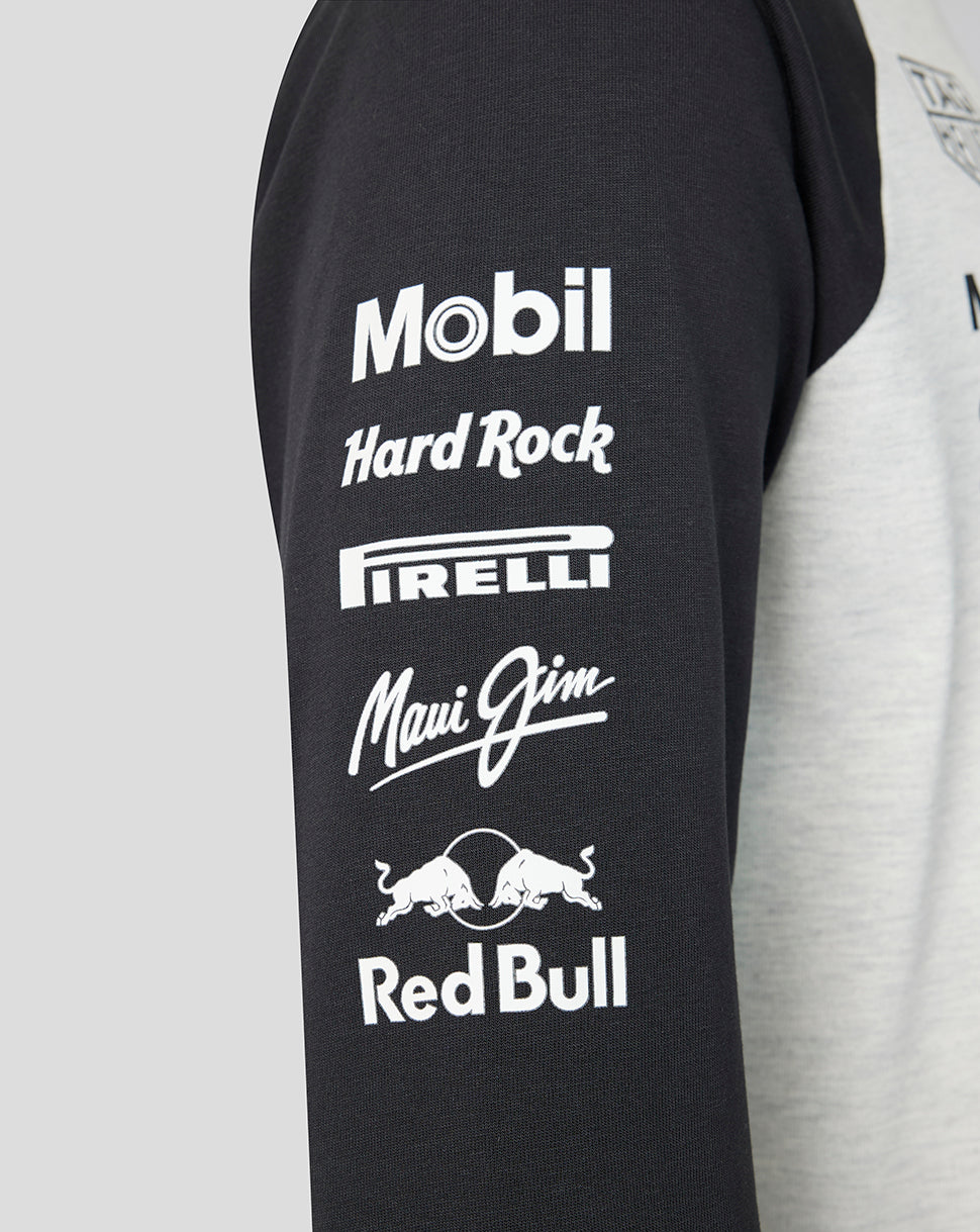 Black sleeveless shirt with various brand logos on a gray background