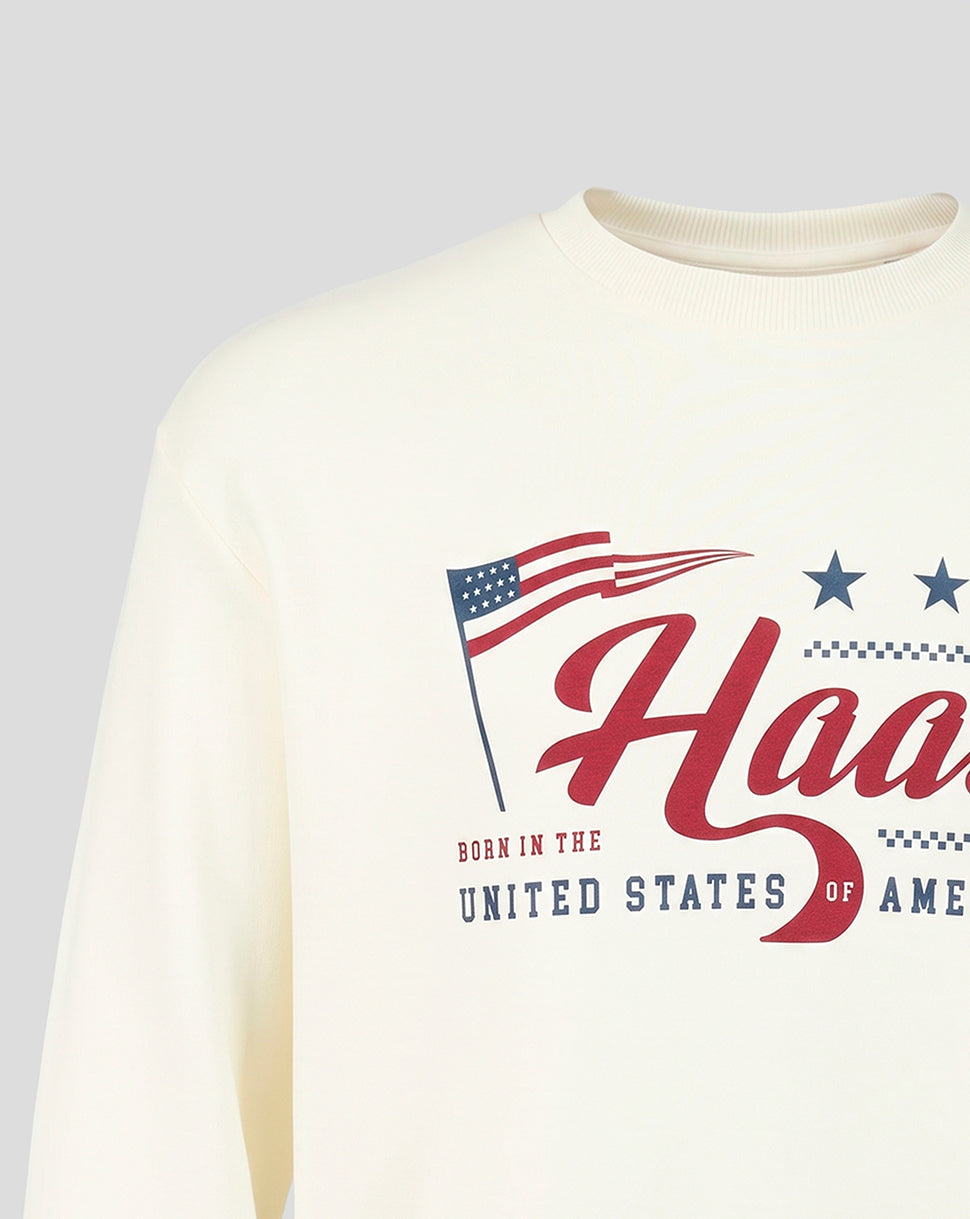 Front view of cream Haas Team USA flag sweater with large red Haas script and blue stars.