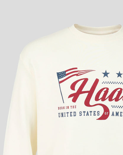 Front view of cream Haas Team USA flag sweater with large red Haas script and blue stars.