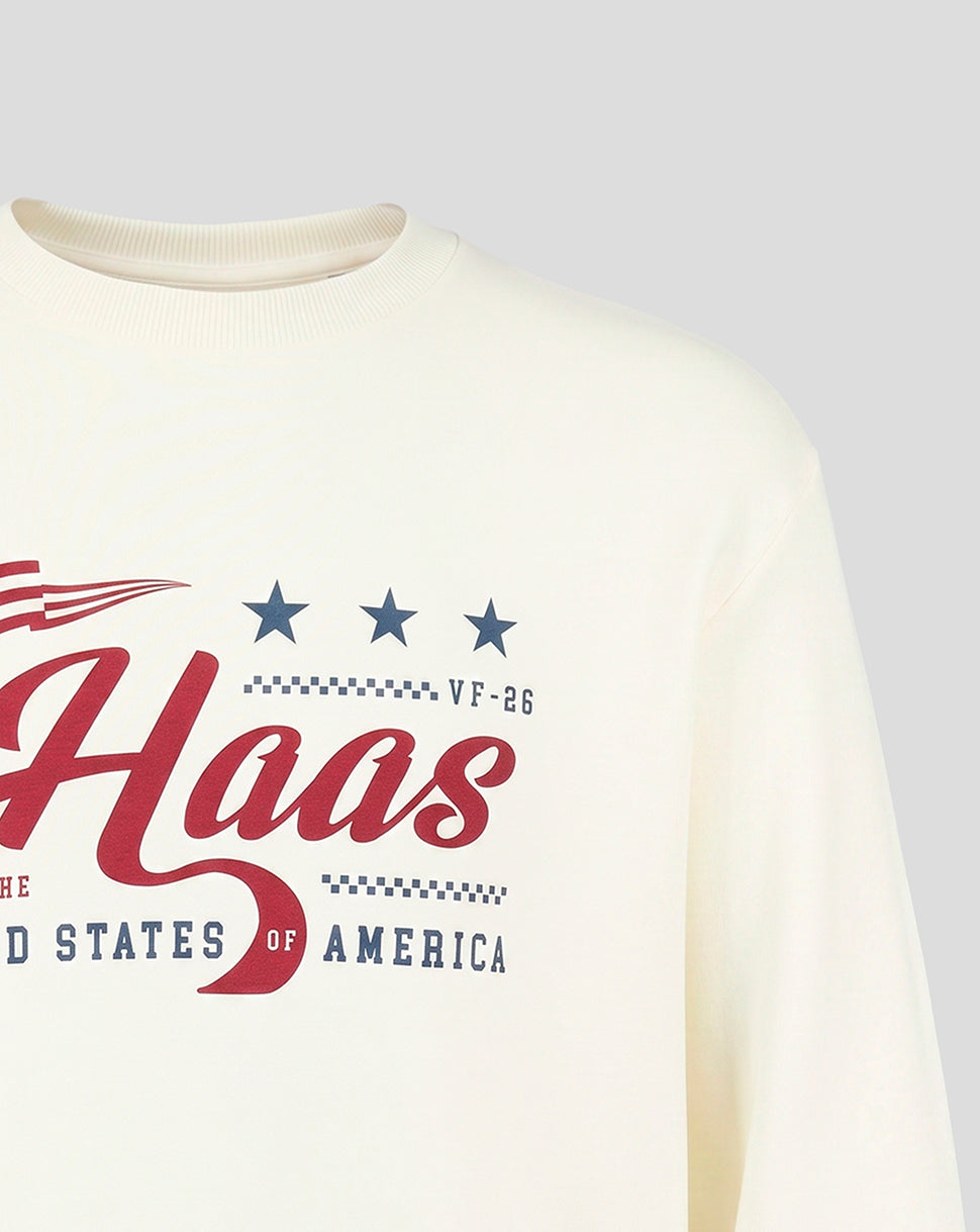Close up of cream Haas Team USA flag sweater front with bold red Haas script and blue stars.