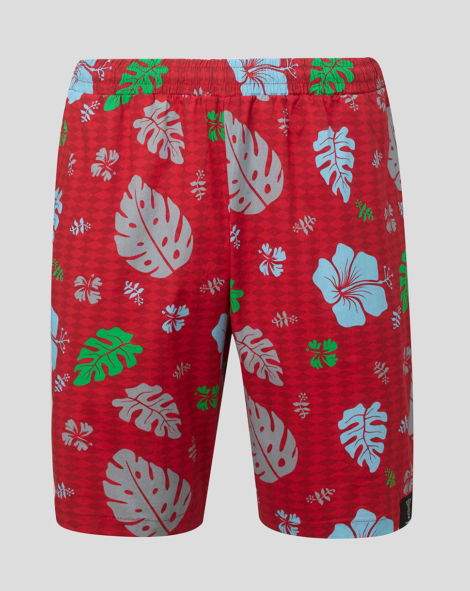 Red shorts with tropical leaf pattern on a gray background