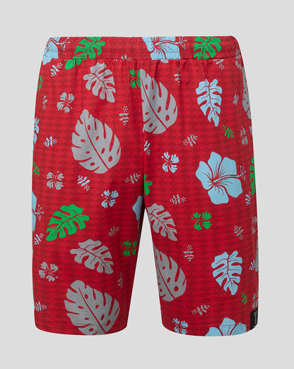 Red shorts with tropical leaf pattern on a gray background