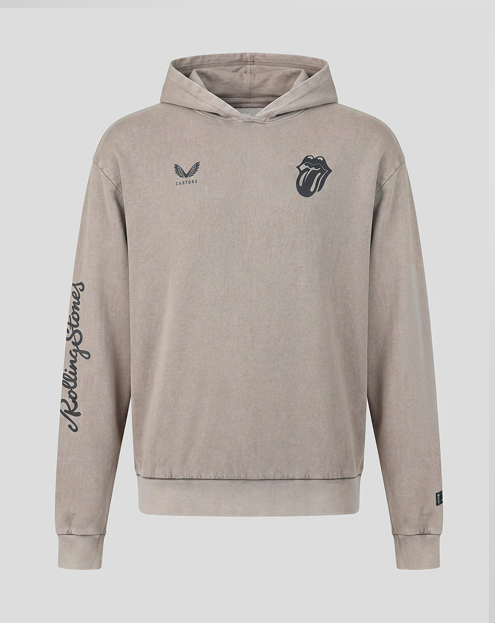 A beige hooded sweatshirt featuring the Rolling Stones tongue and lips logo on the left chest, a small wing logo with 'Castore' on the right chest, and 'Rolling Stones' written vertically in script down the right sleeve, shown against a light gray background.
