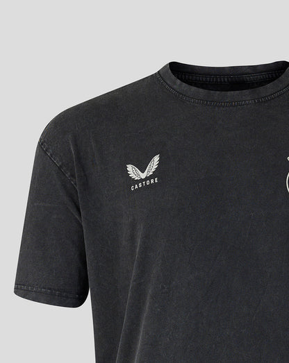 Close-up of a dark washed charcoal gray t-shirt featuring a white embroidered winged logo and the word 'CASTORE' on the left chest, set against a light gray background.