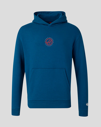 A dark teal blue pullover hoodie with a small circular red and white graphic on the left chest, displayed on a neutral gray background.