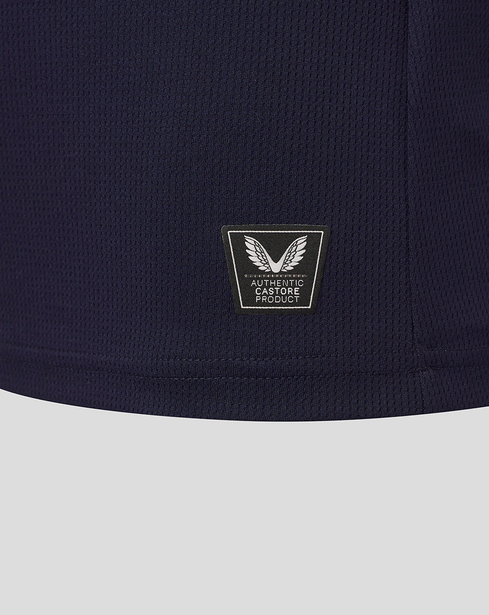 Close-up of navy fabric showing Authentic Castore Product badge with a winged emblem near the lower back